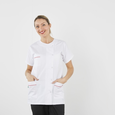 Tunique médicale Julia blanche à liseré rouge portée avec un pantalon noir